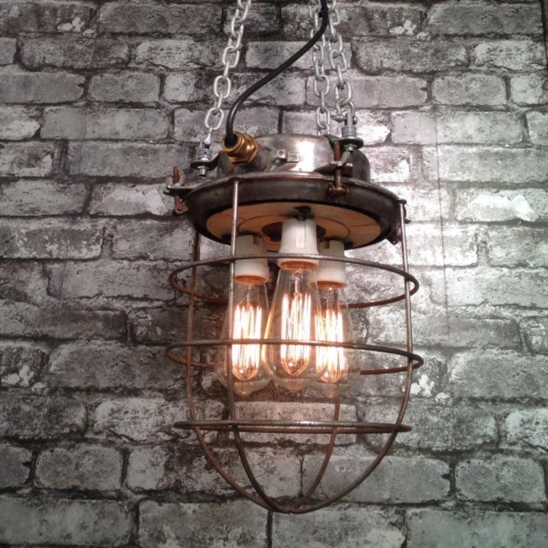 Reclaimed industrial steampunk style ceiling cage light with filament bulbs..  